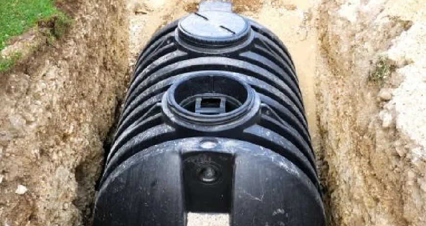 New plastic septic tank placed in a trench during home construction